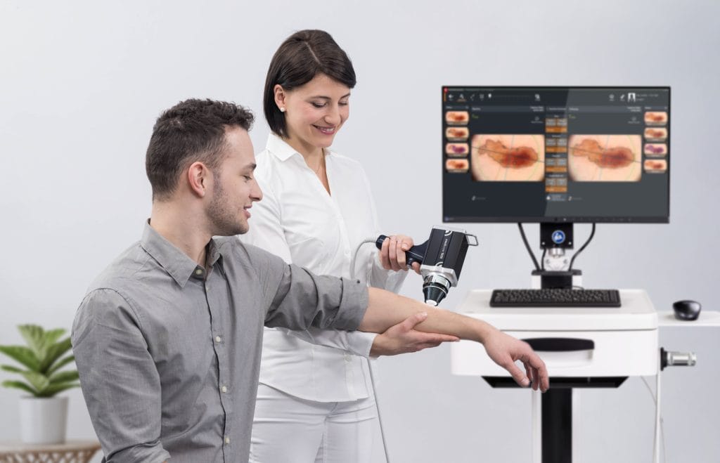 Specialist performing advanced mole mapping and skin cancer screening using digital dermoscopy technology for early detection of melanoma, BCC, and SCC.